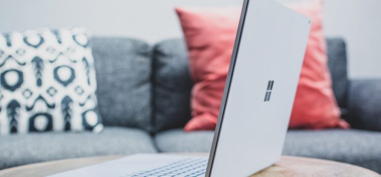 Have You Tried Out Microsoft Designer Yet? (Get the Scoop Here) macbook pro on white couch