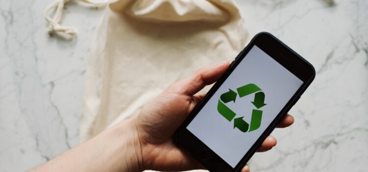11 Ways to Responsibly Get Rid of E-Waste at Your Home or Office Free Faceless person showing recycle symbol on mobile phone screen Stock Photo