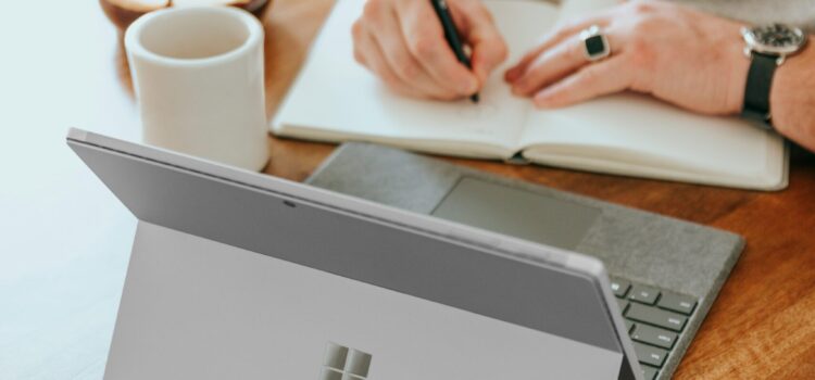 4 Ways Small Businesses Can Leverage Copilot for Microsoft 365 a man sitting at a table writing on a notebook
