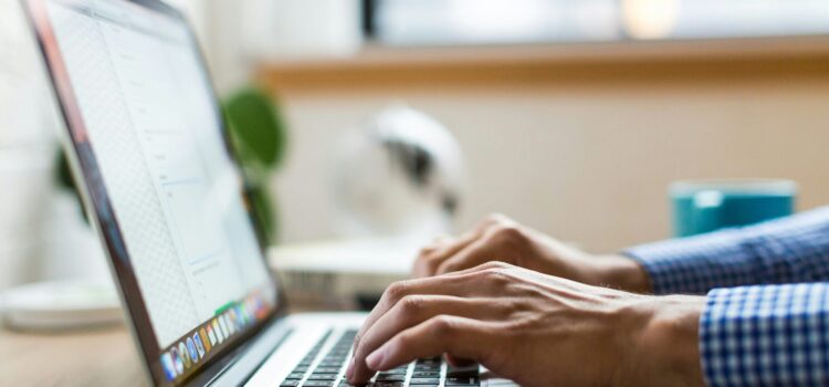 Is Your Business Losing Money Because Employees Can’t Use Tech? person typing on silver Macbook