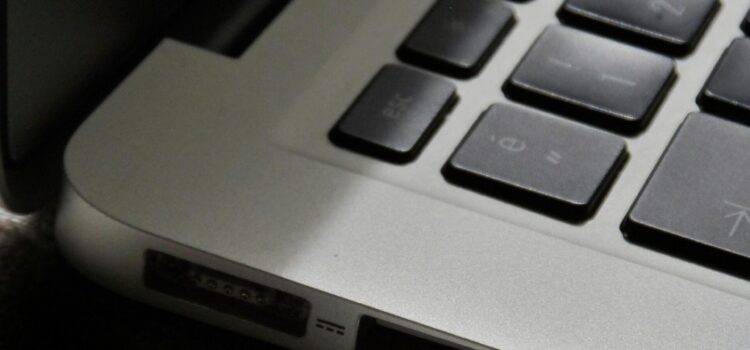 The “Zombie” SaaS Audit: Finding the 3 Apps Your Former Employees Still Access Free Detailed view of a silver laptop showing keyboard and multiple ports. Stock Photo
