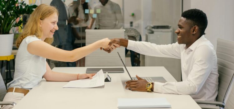 Why Bad Onboarding Is the Real Cause of Messy Offboarding Free Business professionals completing a successful deal with a handshake in a modern office setting. Stock Photo