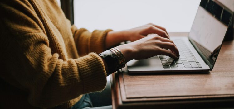 What Are Passkeys, and Should Your Business Use Them? person sitting front of laptop