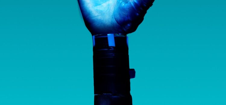 alt="Free Prosthetic Arm on Blue Background Stock Photo"