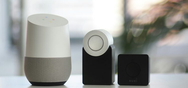 white and gray Google smart speaker and wo black speakers