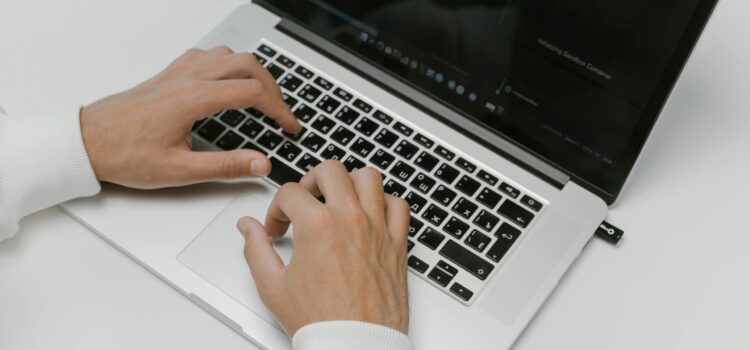 Free Hands on a Laptop Keyboard Stock Photo